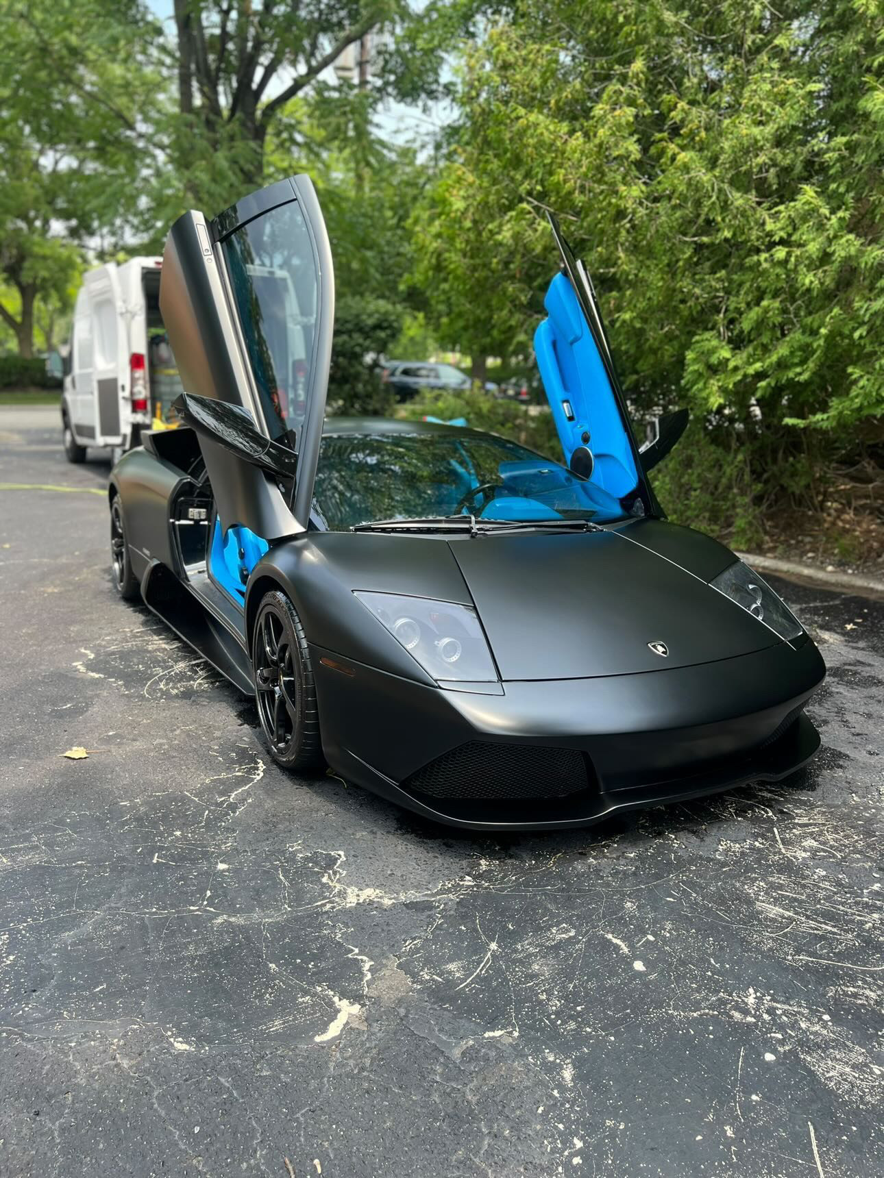 Matte black Lamborghini Murciélago after detailing with scissor doors open